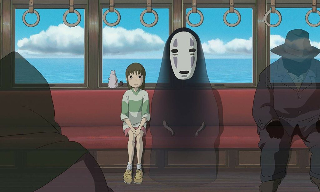 Image tirée du film Le Voyage de Chihiro où on voit Chihiro dans un train avec des esprits. 